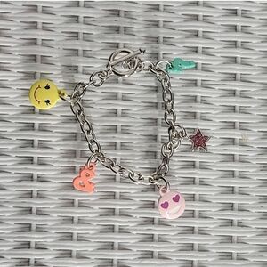 Silver and Yellow Charm Bracelet with Playful Jewelry Accents